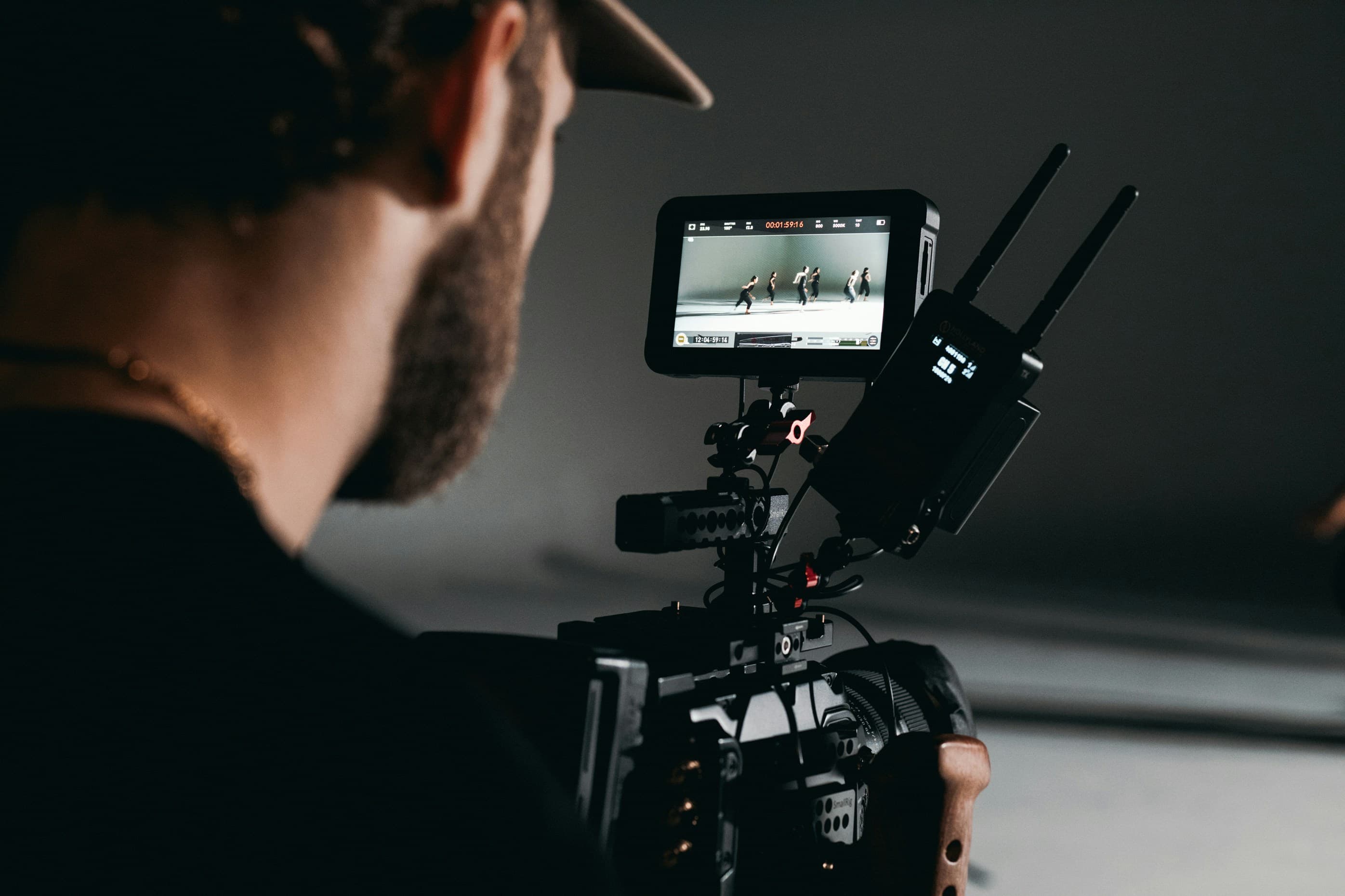 Operator behind a camera monitor on set during production.